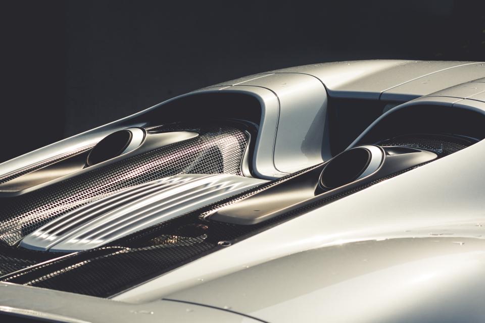 A curved car panel with a clean straight reflection running across it