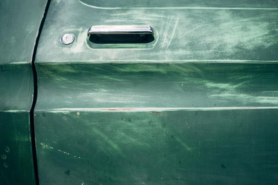 Car door with a sharp bodyline where a crease dent forms